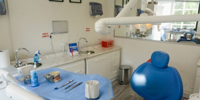 Clean and organized dental examination room with equipment and instruments ready for patient care.